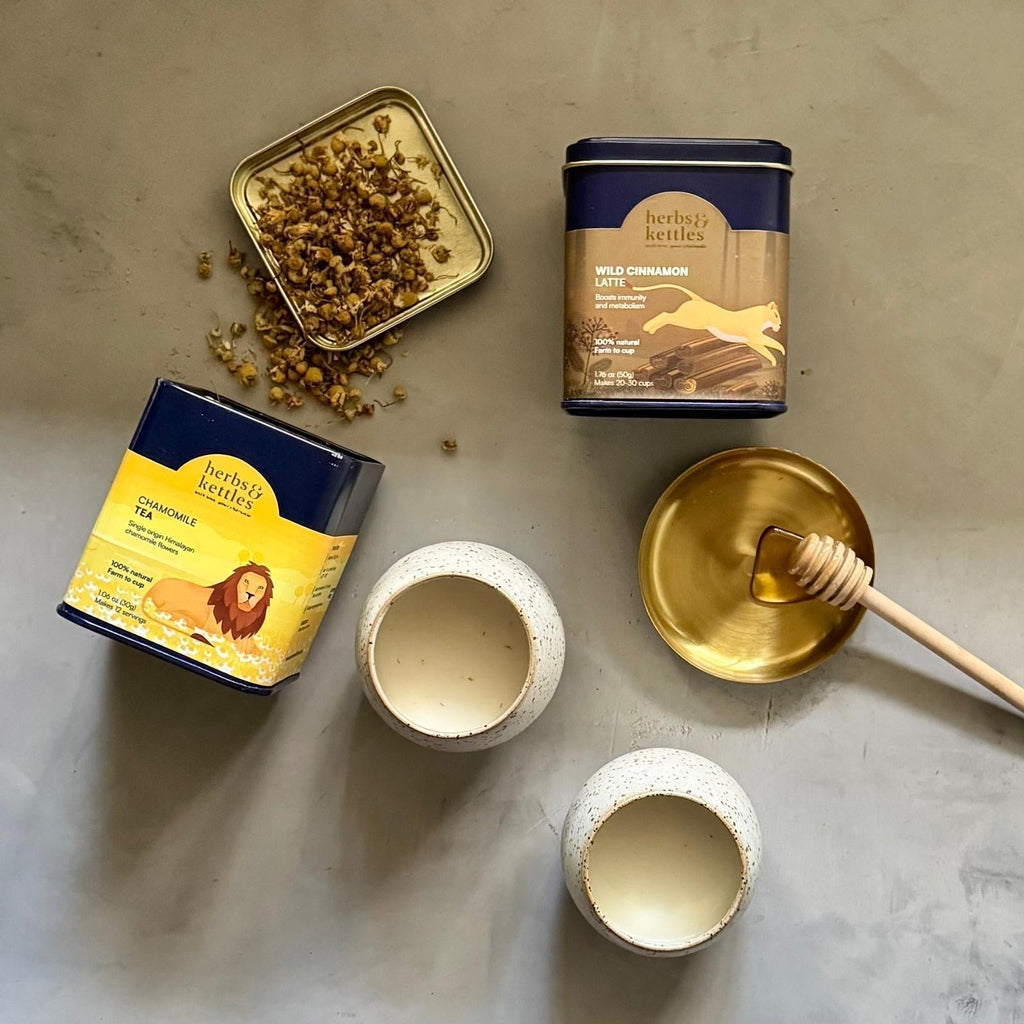 photo of lunar spiced herbal milk latte with Chamomile Tea Tin and Wild Cinnamon Tea Tin