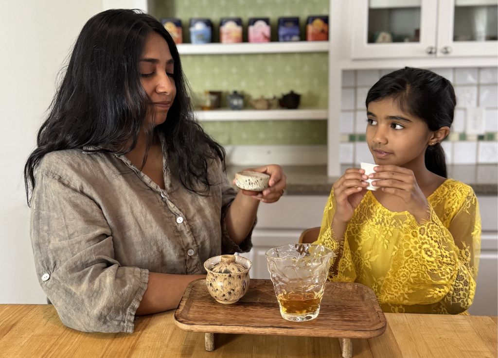 a photo of a mother and child drinking tea
