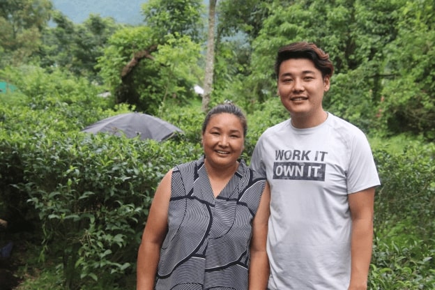 photo of Yanki and Allan in their village and surrounding tea farms